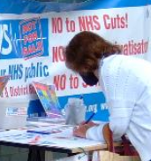 Person signing NHS birthday card